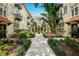 Charming courtyard view with lush landscaping and a decorative fountain in a vintage apartment complex at 2117 W Dekle Ave # D1, Tampa, FL 33606