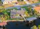 Aerial view of a waterfront home with well-manicured landscaping, private dock, and canal access for easy boating at 220 Singapore Rd, Punta Gorda, FL 33950