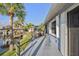 Waterside deck with tropical landscaping, grill, and hot tub at 220 Singapore Rd, Punta Gorda, FL 33950