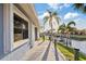 Backyard with a waterfront view, wooden deck, and lush tropical landscaping at 220 Singapore Rd, Punta Gorda, FL 33950