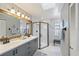 Modern bathroom features a double sink vanity and a black framed glass shower at 220 Singapore Rd, Punta Gorda, FL 33950