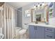 Well-lit bathroom featuring a bathtub with shower, toilet, and vanity with a framed mirror at 220 Singapore Rd, Punta Gorda, FL 33950