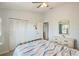 Comfortable bedroom with a patterned quilt, light-colored walls, and ample closet space at 220 Singapore Rd, Punta Gorda, FL 33950