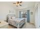 Bright bedroom featuring a metal bed frame, colorful bedding, and a ceiling fan at 220 Singapore Rd, Punta Gorda, FL 33950