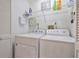 Efficient laundry room with modern washer and dryer, shelving, and ample storage space at 220 Singapore Rd, Punta Gorda, FL 33950