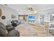 Spacious living room with vaulted ceilings, a ceiling fan, a large TV, and comfortable leather seating at 220 Singapore Rd, Punta Gorda, FL 33950