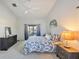 Light-filled main bedroom with a ceiling fan, beachy decor, and a sliding glass door with patio access at 220 Singapore Rd, Punta Gorda, FL 33950