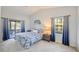 Bright main bedroom with a ceiling fan, a comfortable bed, and a sliding glass door leading to the outdoor patio at 220 Singapore Rd, Punta Gorda, FL 33950