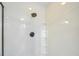 A crisp, clean shower stall with a black shower head and built-in shelving at 220 Singapore Rd, Punta Gorda, FL 33950