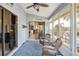 Bright sunroom with wicker rocking chairs and views of the canal at 220 Singapore Rd, Punta Gorda, FL 33950