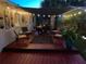 Cozy back patio featuring a shade sail, string lights, and outdoor seating, perfect for relaxing evenings at 2400 62Nd N St, St Petersburg, FL 33710