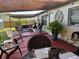 Inviting back patio with comfortable seating and a shade sail, ideal for outdoor entertaining and enjoying the backyard at 2400 62Nd N St, St Petersburg, FL 33710