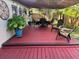 Back patio with comfortable seating, a shade sail, and lush greenery, perfect for outdoor gatherings at 2400 62Nd N St, St Petersburg, FL 33710