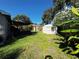 Expansive backyard with a patio, storage shed, and lush greenery, offering ample space for outdoor activities at 2400 62Nd N St, St Petersburg, FL 33710