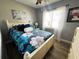 Bedroom featuring a full bed, floral-themed bedding, and neutral-toned walls at 2400 62Nd N St, St Petersburg, FL 33710