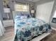 Bedroom features floral bedding, two windows, and neutral decor at 2400 62Nd N St, St Petersburg, FL 33710