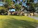 Charming single-story home with a well-manicured lawn and mature trees providing ample shade at 2400 62Nd N St, St Petersburg, FL 33710