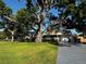 Charming single-story home with a well-manicured lawn and mature trees providing ample shade at 2400 62Nd N St, St Petersburg, FL 33710