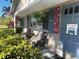 Charming front porch with seating area, decorative plants, and welcoming patriotic decor at 2400 62Nd N St, St Petersburg, FL 33710