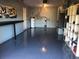Spacious garage featuring epoxy flooring, a workbench, and storage shelves at 2400 62Nd N St, St Petersburg, FL 33710