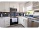 Well-equipped kitchen with stainless steel appliances, granite countertops, and ample cabinet space at 2400 62Nd N St, St Petersburg, FL 33710