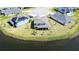 Aerial view of the backyard of the home, showcasing the lush green lawn and a nearby lake at 2563 Ocean Breeze Ln, Clearwater, FL 33761