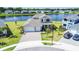 Aerial view of a two-story home with a well-maintained lawn, a large driveway, and lush landscaping at 2563 Ocean Breeze Ln, Clearwater, FL 33761