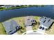Aerial view of a home next to a large lake with neighboring houses and green lawns at 2563 Ocean Breeze Ln, Clearwater, FL 33761