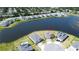 Drone shot of the house near lake in a community with manicured lawns and mature landscaping at 2563 Ocean Breeze Ln, Clearwater, FL 33761