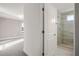 En-suite bathroom with a glass shower, modern fixtures, and access to a bedroom for convenience at 2563 Ocean Breeze Ln, Clearwater, FL 33761