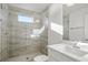 Stylish bathroom featuring a tiled shower with glass door, modern vanity, and a clean, bright design at 2563 Ocean Breeze Ln, Clearwater, FL 33761