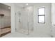 This bathroom features a glass shower, marble floors, and walk-in closet at 2563 Ocean Breeze Ln, Clearwater, FL 33761