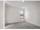 A minimalistic bedroom with neutral carpet, white walls, and a view of the lake at 2563 Ocean Breeze Ln, Clearwater, FL 33761