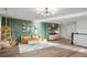 Cozy bonus room with stylish seating, green accent wall, and unique decorative elements for relaxation at 2563 Ocean Breeze Ln, Clearwater, FL 33761