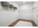 Spacious walk-in closet with built-in shelving and wood floors at 2563 Ocean Breeze Ln, Clearwater, FL 33761