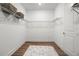 A walk-in closet features wood floors, a wire shelving system, and white walls at 2563 Ocean Breeze Ln, Clearwater, FL 33761