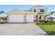 Charming home with a well-manicured lawn, a paved driveway, and a two-car garage at 2563 Ocean Breeze Ln, Clearwater, FL 33761