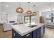 Kitchen with quartz countertop island, pendant lighting, and views into the living room and backyard at 2563 Ocean Breeze Ln, Clearwater, FL 33761