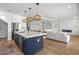 Open concept kitchen with large island, pendant lighting, stainless steel appliances, and seamless flow to the living area at 2563 Ocean Breeze Ln, Clearwater, FL 33761