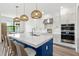 Modern kitchen featuring a large island, stainless steel appliances, and stylish pendant lighting at 2563 Ocean Breeze Ln, Clearwater, FL 33761