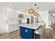 Stunning kitchen with a large island, white cabinets, quartz counters, and modern lighting fixtures at 2563 Ocean Breeze Ln, Clearwater, FL 33761