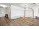 Elegant living room with modern lighting, hardwood floors, and an arched alcove at 2563 Ocean Breeze Ln, Clearwater, FL 33761
