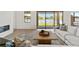 Cozy living room with modern fireplace, accent rug, and lake view at 2563 Ocean Breeze Ln, Clearwater, FL 33761