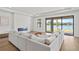 Bright living room with modern fireplace and large sliding glass doors offering lake views at 2563 Ocean Breeze Ln, Clearwater, FL 33761