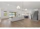 Open-concept living room with wood floors, lake view, and a modern kitchen in the background at 2563 Ocean Breeze Ln, Clearwater, FL 33761
