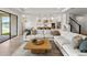 Open-concept living room showcasing kitchen, stairway, and stylish decor at 2563 Ocean Breeze Ln, Clearwater, FL 33761