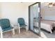 Balcony with seating area leading to a bedroom with comfortable beds at 2595 Countryside Blvd # 8205, Clearwater, FL 33761