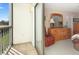 Bright bedroom featuring balcony access, neutral carpet, dresser, and accent chair at 2595 Countryside Blvd # 8205, Clearwater, FL 33761