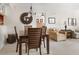A dining room with a wood table and chairs, with seating for four, adjacent to the living area and kitchen at 2595 Countryside Blvd # 8205, Clearwater, FL 33761