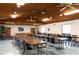 Recreation room with multiple tables, chairs, ceiling fans, and windows at 2595 Countryside Blvd # 8205, Clearwater, FL 33761